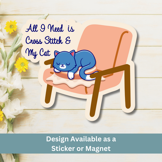 Magnet of cat and cross stitch design on wood flat lay