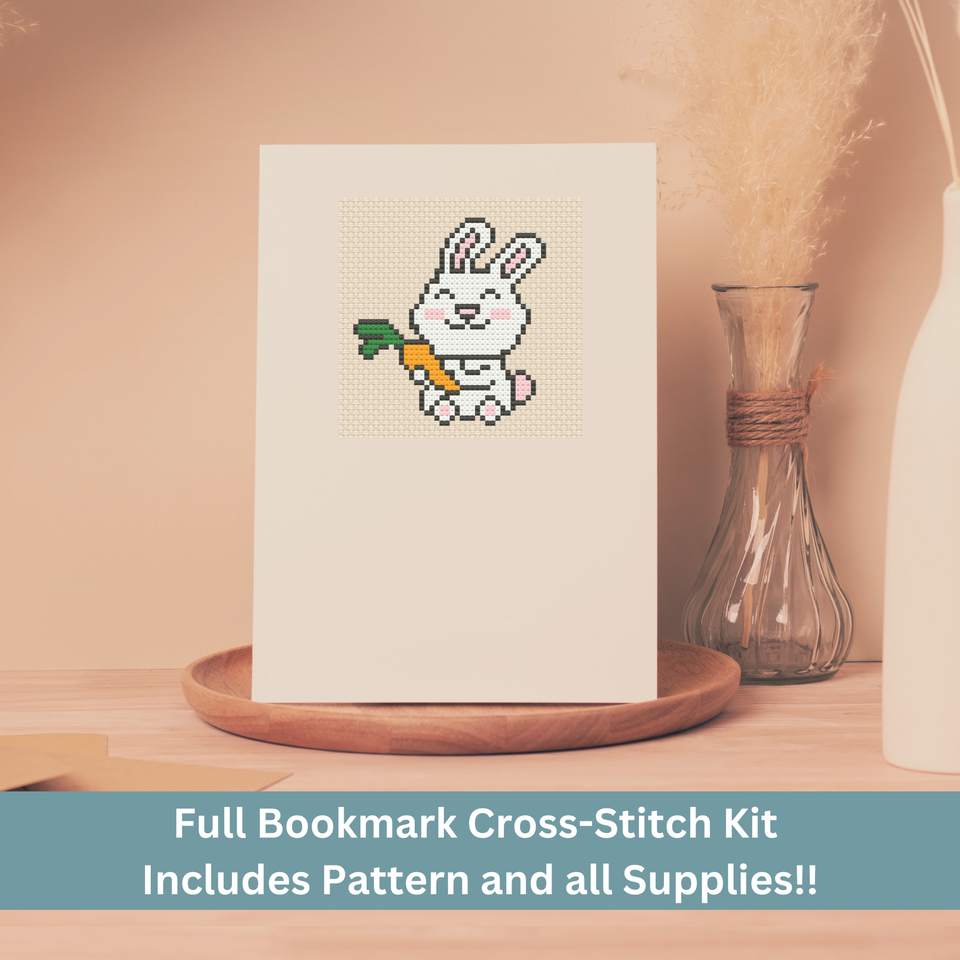 Cross-stitch greeting card featuring a white bunny holding a carrot, stitched on Aida cloth.
