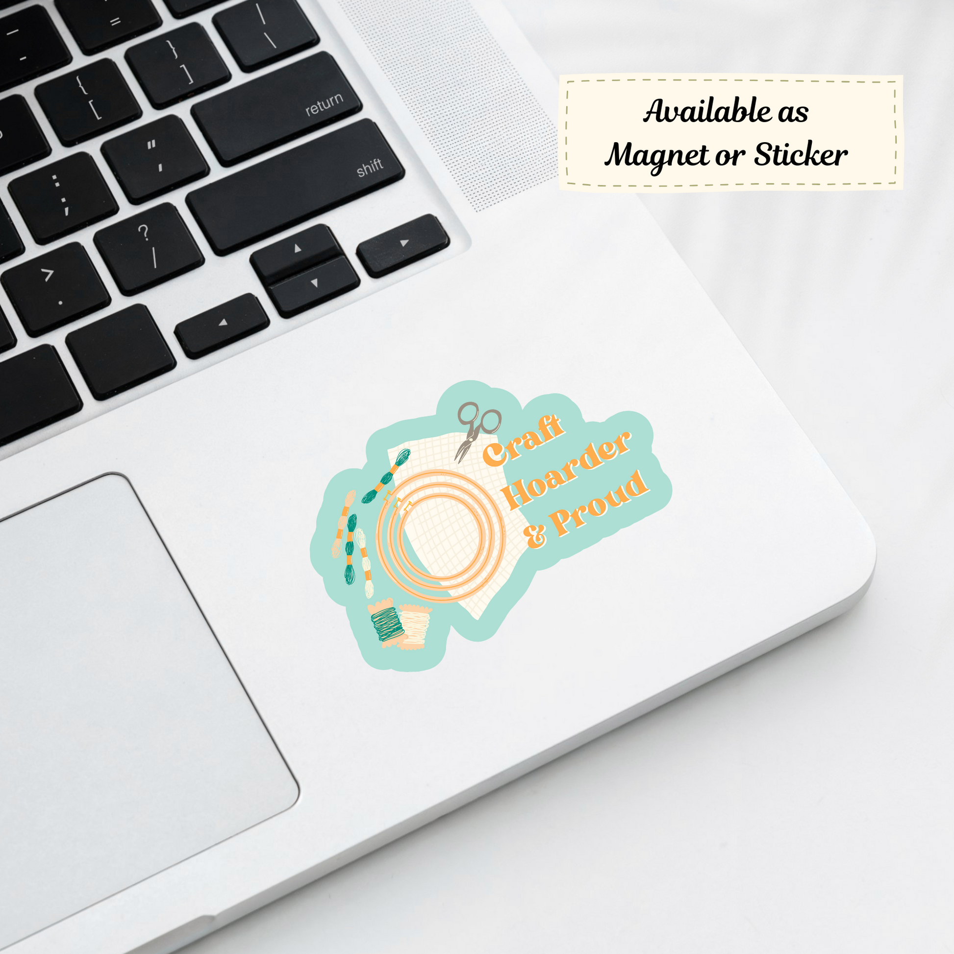 Fun craft hoarding sticker on a laptop near supplies.