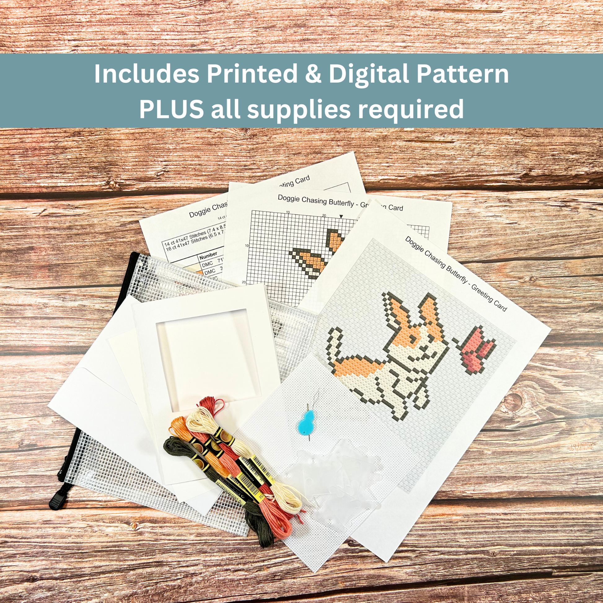 Complete cross-stitch kit contents, including fabric, thread, needle, pattern sheets, and greeting card materials.