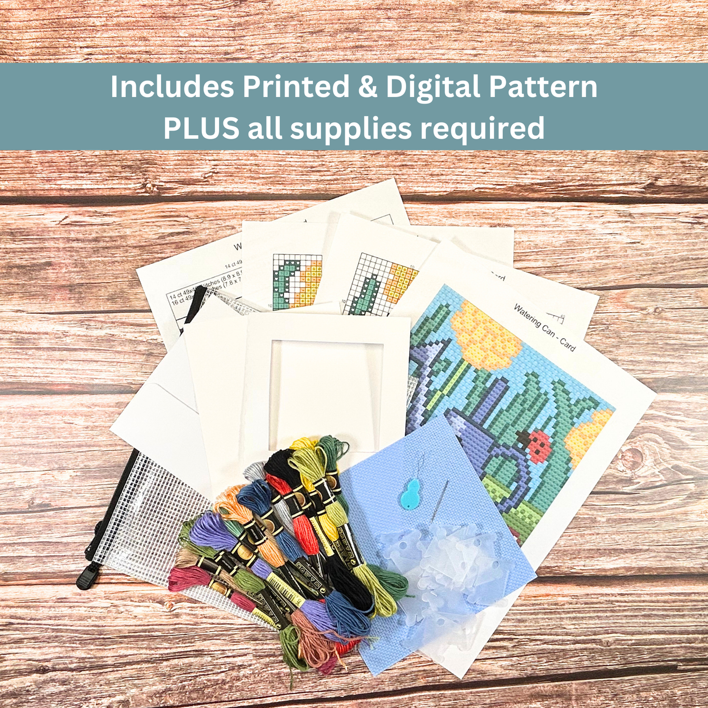 Complete cross-stitch kit including Aida cloth, embroidery floss, pattern sheets, and greeting card materials.
